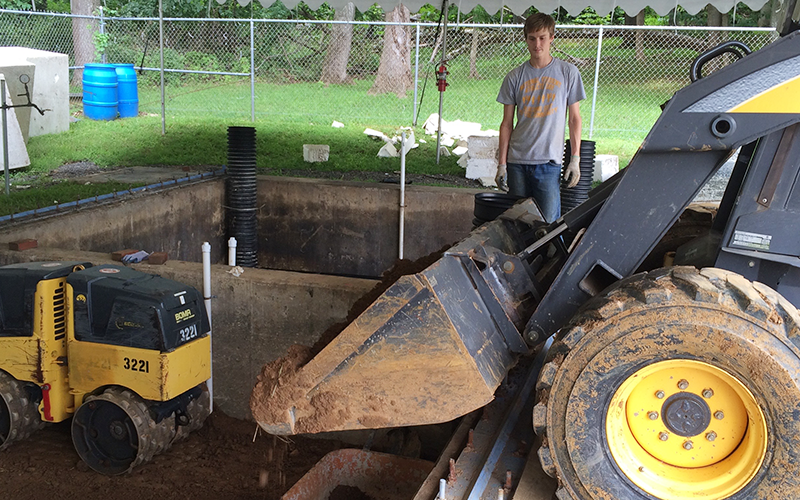 Student with construction equipment