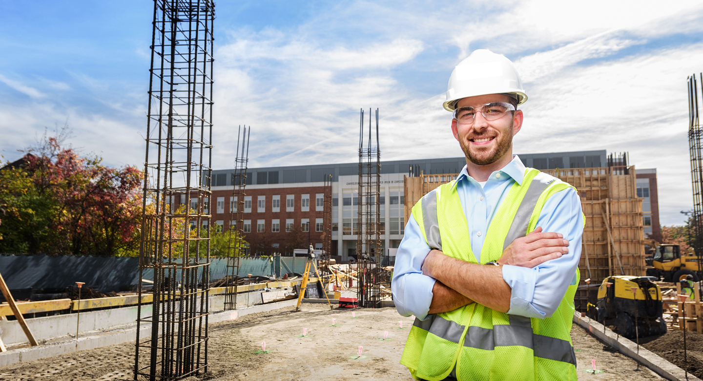 Civil engineer stands at build site